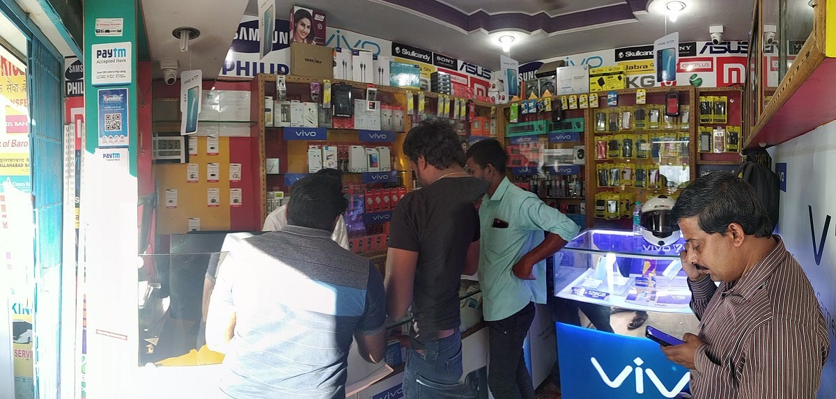 Customers at a cellphone store remit money through Eko’s money transfer service.