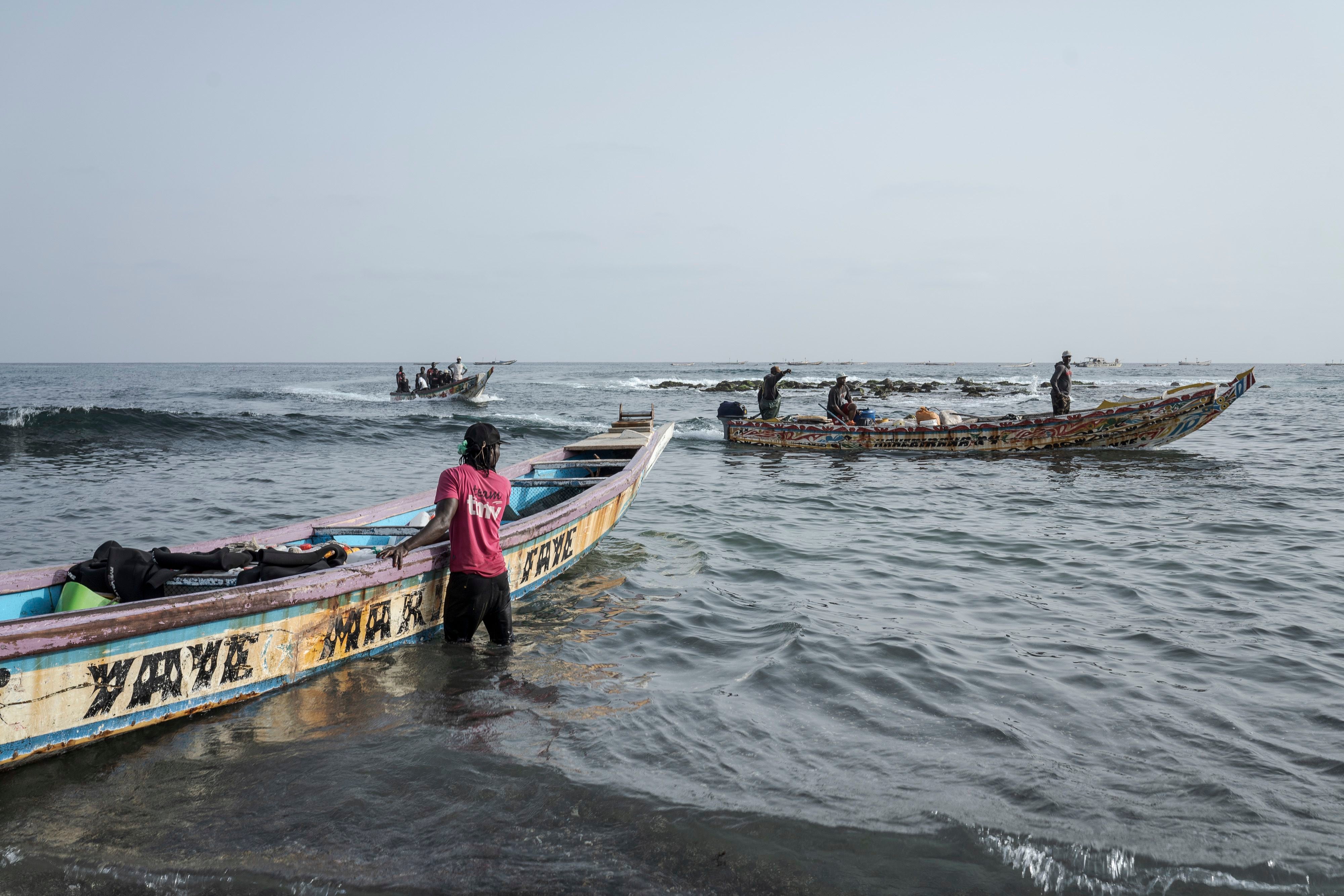A fishermen arrives onto a beach in Dakar, Senegal.