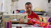 A tailor works in his workshop.