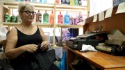 A woman sits in her shop