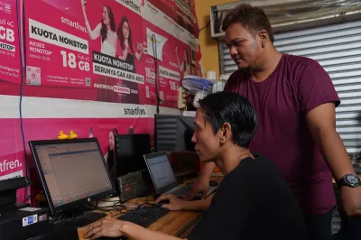 Two men look at a computer
