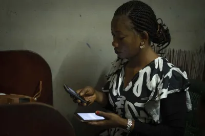 A woman looks at her smartphone