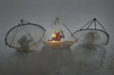 Women in the water in India with fishing nets
