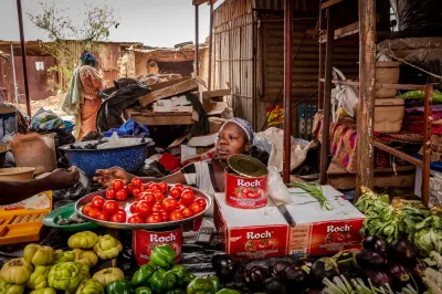 A woman sells produce at a street market in Burkina Faso