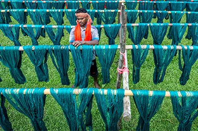 Bangladeshi worker coloring and drying cloth material, Bangladesh. Photo by Sohel Parvez Haque, 2017 CGAP Photo Contest