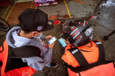 Two men look at smartphone screens