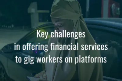 woman on phone in front of car