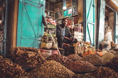 A grocer sits outside his shop in Sudan. Photo: Mohamed Faisal, 2018 CGAP Photo Contest
