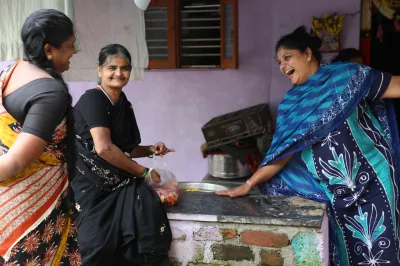 women in saris laugh