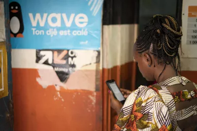 Woman uses her mobile to access digital financial services