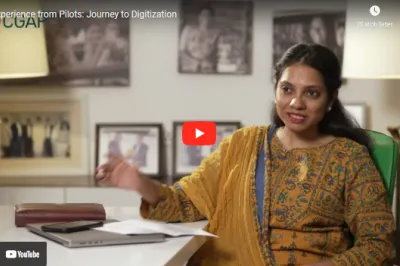 woman in indian dress sitting at a desk