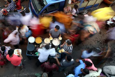 Street vendors serve food in a crowd