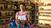 A woman stands in her handicraft shop in Mexico
