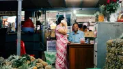 Two people chat in a night market stall