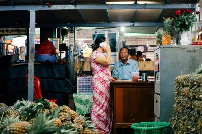 Two people chat in a night market stall